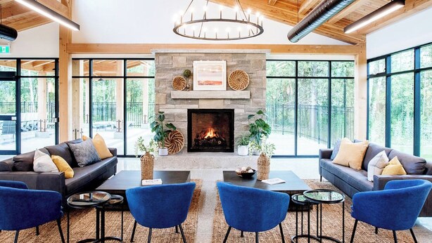 A spacious lobby with a fireplace, modern furniture, and large windows offering a view of the outdoors. - Bright, spacious, amazing view at a prime location (The Blue Mountains)