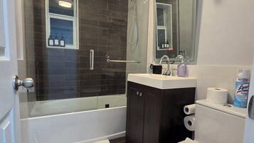 Shower, hair dryer, towels, shampoo