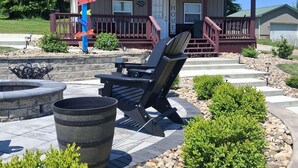 A building with a porch, outdoor seating, and a decorative sign. - Charming & Cozy 1-bedroom cottage at Seneca Lake, Senecaville. OH (Senecaville)