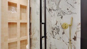 A bathroom with beige tiled walls, a glass shower enclosure, and a marble backsplash. - Cosy Appt - 1bdr/2p - Moulin Rouge / Montmartre (Paris)