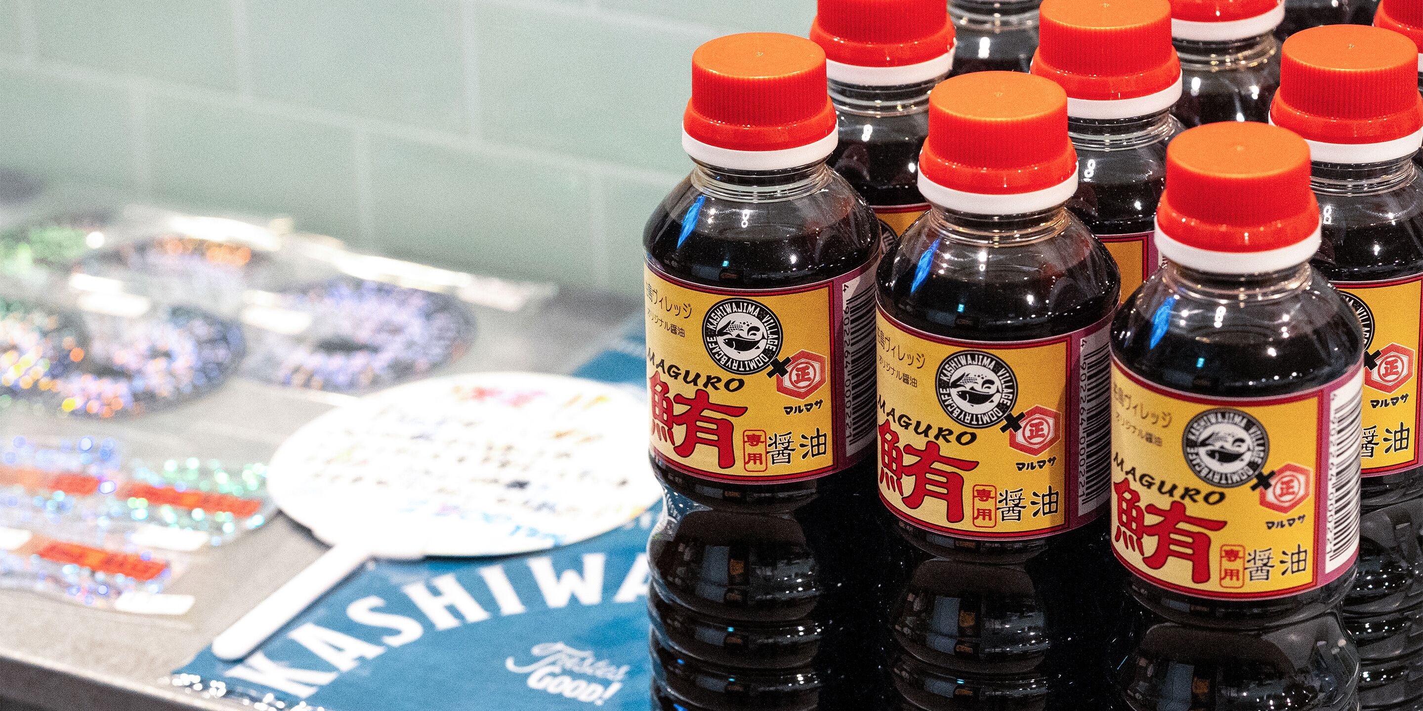 A display of bottles with red caps and labels, arranged closely together.