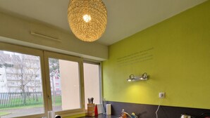 A modern kitchen with a large window, a sink, and a dishwasher.
