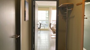 A hallway with a door leading to a balcony area. - Apartment in Nieuwpoort Near the Beach (Nieuwpoort)