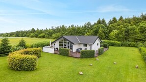 A modern house with a large patio, surrounded by a well-maintained lawn and dense forest. - "Naimi" - 30km from the sea by Interhome (Toftlund)