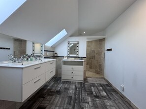 A modern bathroom with a skylight, dual sinks, a vanity with drawers, and a shower area. - Spacious Retreat for 12 With Spa Option (Saint-Mars-d'Outille)