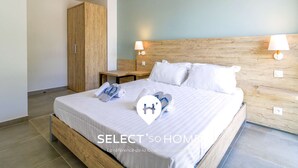 A modern bedroom with a wooden bed frame, two bedside tables, a wardrobe, and a ceiling light.