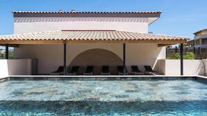 A swimming pool with a covered area and lounge chairs. - Modern duplex with pool and garden, for 6 in Bormes-les-Mimosas (Bormes-les-Mimosas)