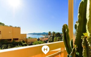 A balcony with a view of the sea and mountains, a cactus in the foreground, and a 'SELECT SO HOME' logo. - Spacious T3 in Lavandou for 5 ppl, terrace near the beach (Le Lavandou)