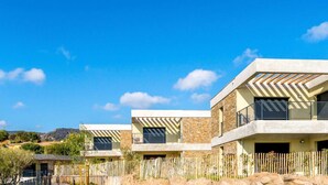 A modern residential complex with multiple houses, a swimming pool, and a natural landscape in the background. - Bright apartment with terraces, pool in secure domain (Bormes-les-Mimosas)