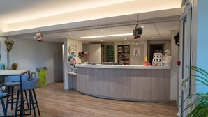 A reception area with a curved counter, bar stools, and a clock on the wall. - Chalet in Normandy Near Veules-les-roses (Veules-les-Roses)