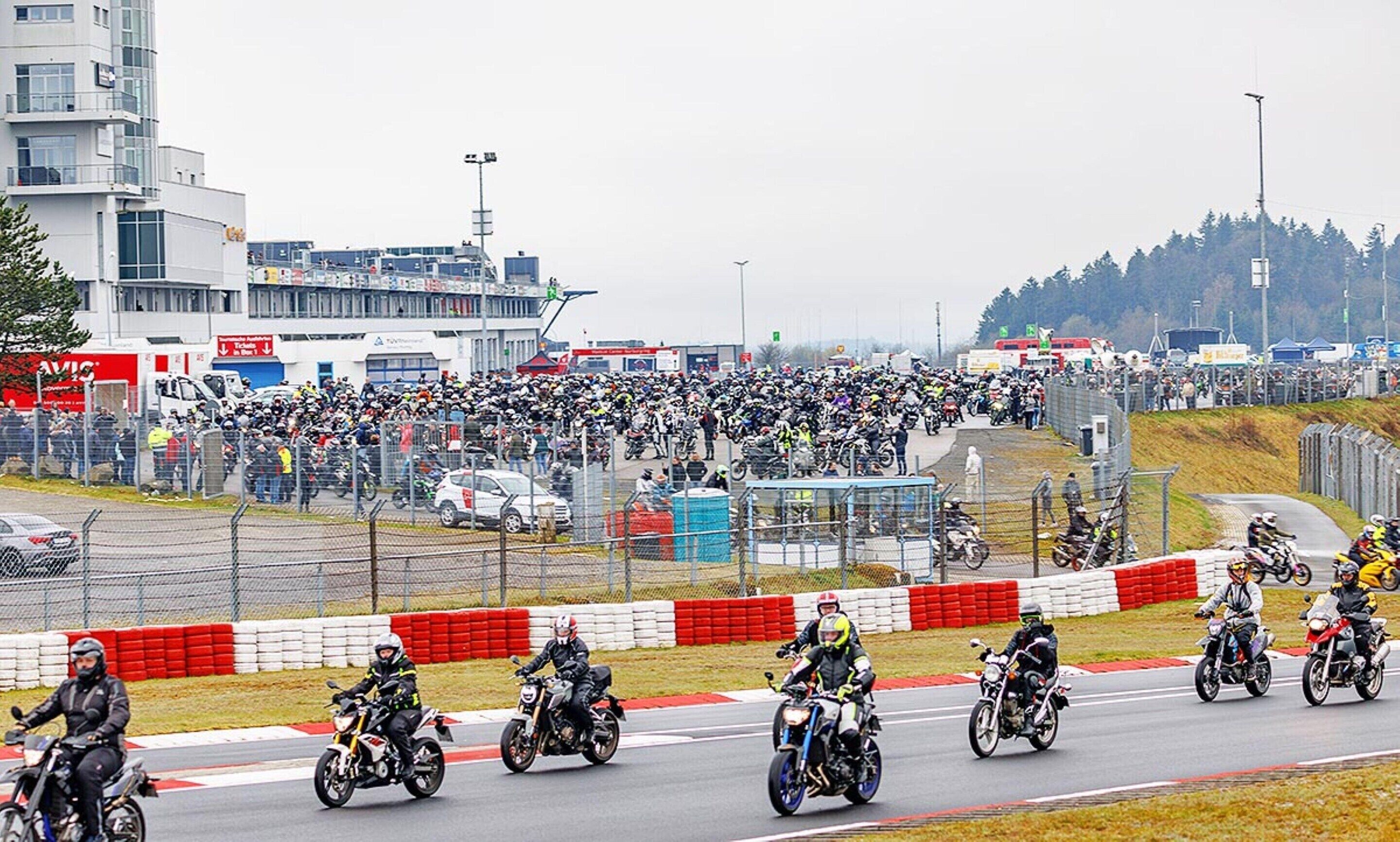 A motorcycle race track with riders in protective gear.