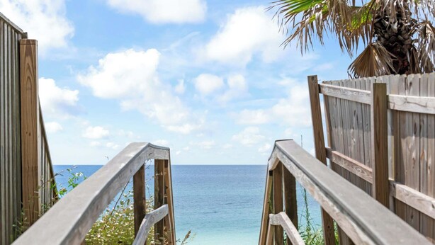 A wooden pathway leading to a beach with a clear view of the ocean. - Gulf Place 30A! Walk to Beach! Pools! Tennis Court! (Santa Rosa Beach)