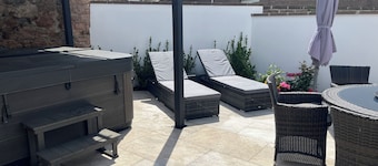 Private cottage/ hot tub / private garden just a short stroll to the beach .