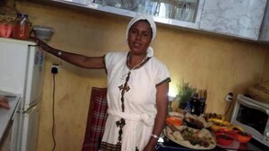 A kitchen with a refrigerator, microwave, and various food items on the counter. - Birhan Guest House (Addis Ababa)