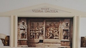 A bed with rolled towels and a carved relief above it. - Vidra Dacica (Vidra)