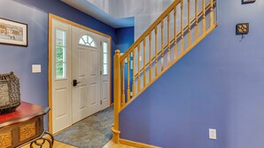 A staircase with wooden railings leading to a door with glass panels. - 2 Mi to Woodbury Wildlife Area: Cozy Farmhouse! (Warsaw)