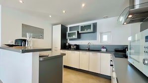 A modern kitchen with a central island, built-in appliances, and a sleek design.
