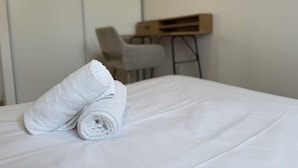 A neatly made bed with two rolled towels on it. - Peaceful Home With Terrace & Parking (Le Mans)