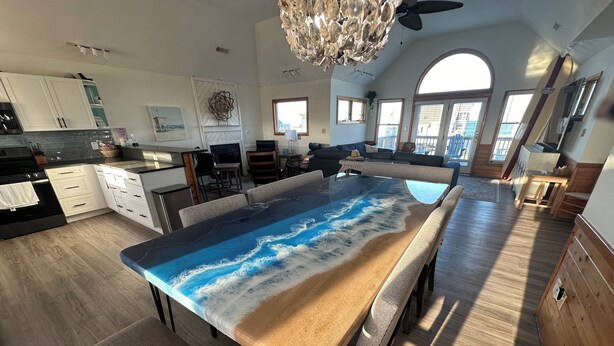 A modern kitchen with a large island, white cabinets, and a view to the outside. - Welcome to Wreckless! Beautiful home with AC and WIFI in delightful Avon (Avon)