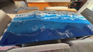 A table with a blue ocean-themed glass top. - Welcome to Wreckless! Beautiful home with AC and WIFI in delightful Avon (Avon)