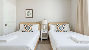 A hotel room with two single beds, a bedside table with a lamp, and a framed picture on the wall. - Cozy 2BR Getaway, 3 Bd/2BA (Glendale)