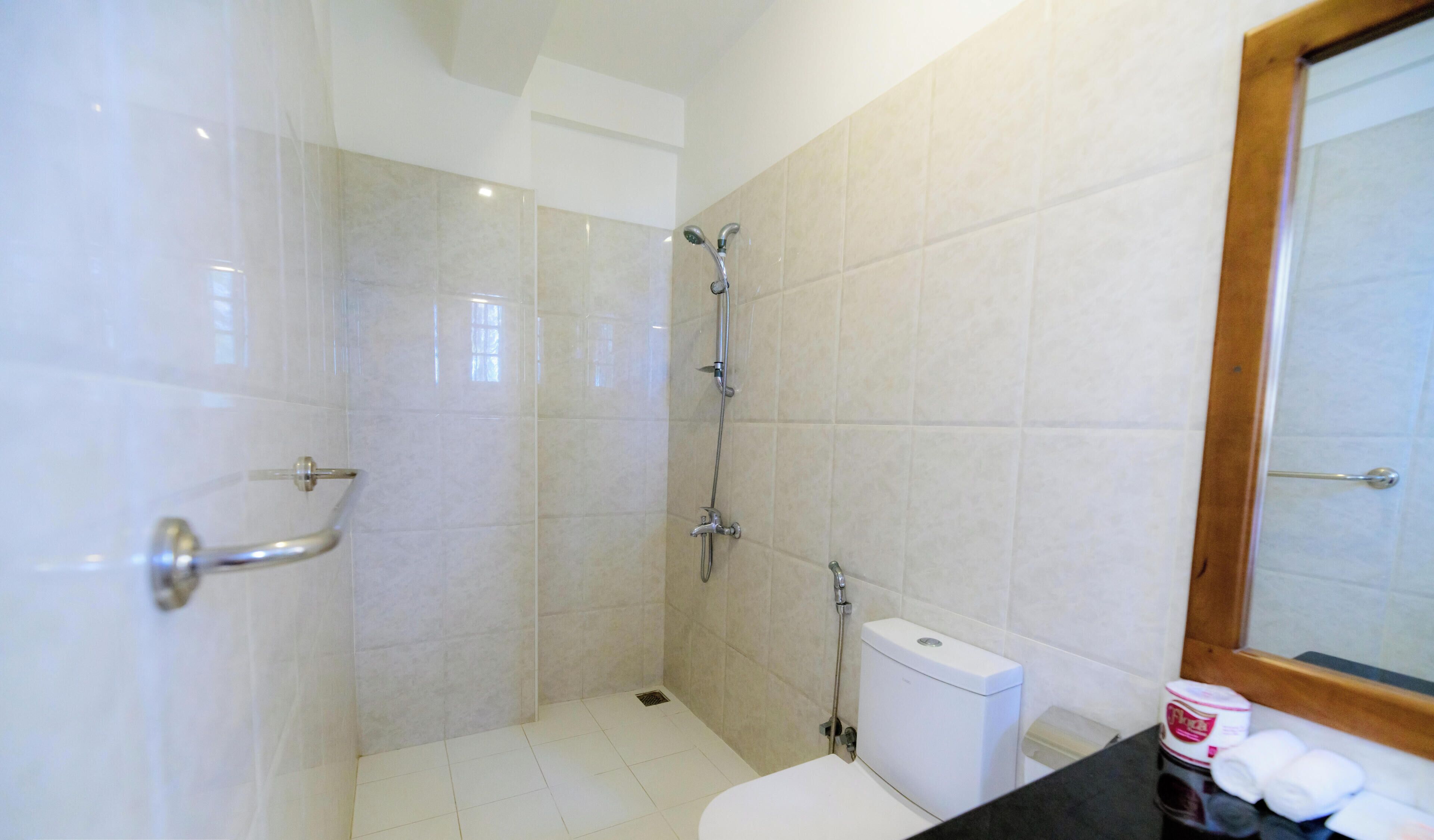 A bathroom with a shower, toilet, and sink.