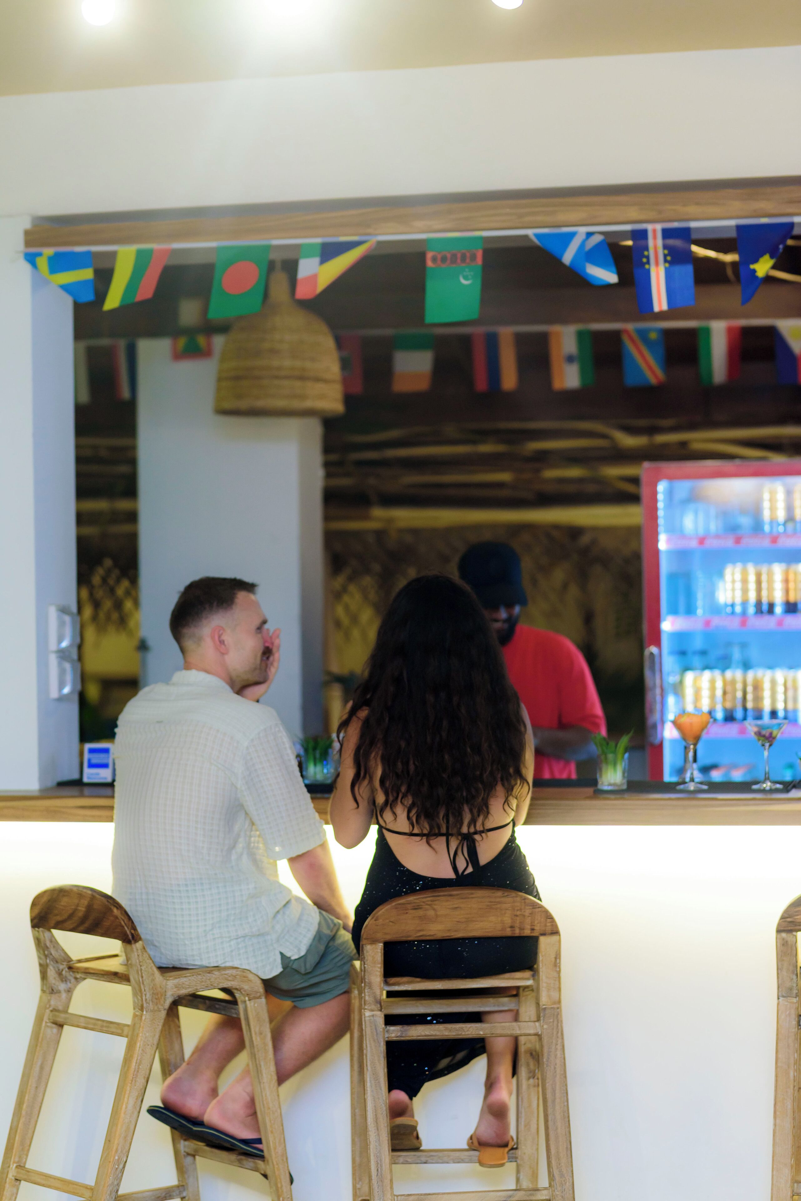 A bar area with stools and a counter.