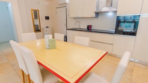 A compact kitchen with white cabinets, a stainless steel sink, and a built-in oven. - 16 Relais du Lac Elite (Desenzano del Garda)