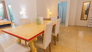 A dining area with a yellow table, white chairs, and a lamp. - 16 Relais du Lac Elite (Desenzano del Garda)