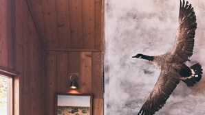 A cozy room with a fireplace, a mounted bird, and a framed picture on the wall. - FIVE MINUTES TO CALAMIGOS RANCH AND CEILO FARMS MOUNTAIN AND OCEAN VIEWS (Malibu)