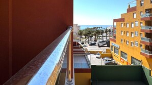 A balcony with a metal railing overlooking a cityscape with buildings and a clear sky. - Premium Apartment in Roquetas de Mar (Roquetas de Mar)