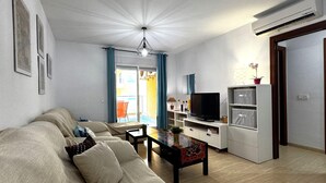 A living room with a sofa, TV, and storage units. - Premium Apartment in Roquetas de Mar (Roquetas de Mar)