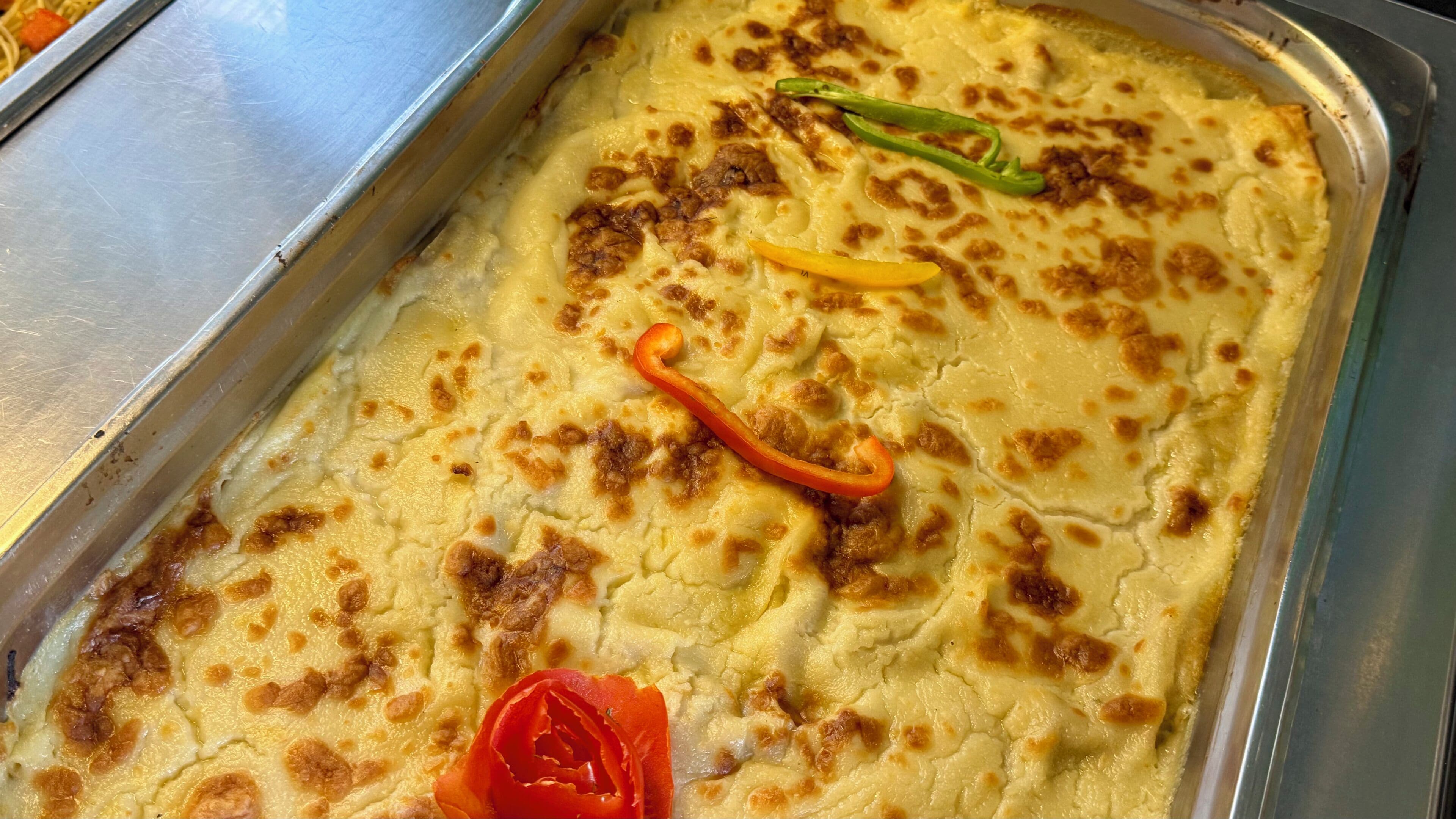 A tray of baked dish with vegetables.