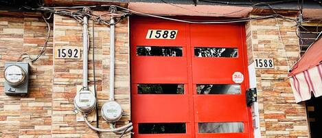 A restaurant sign with the name 'Nuevo Leo' and a red door with the number '1588'.