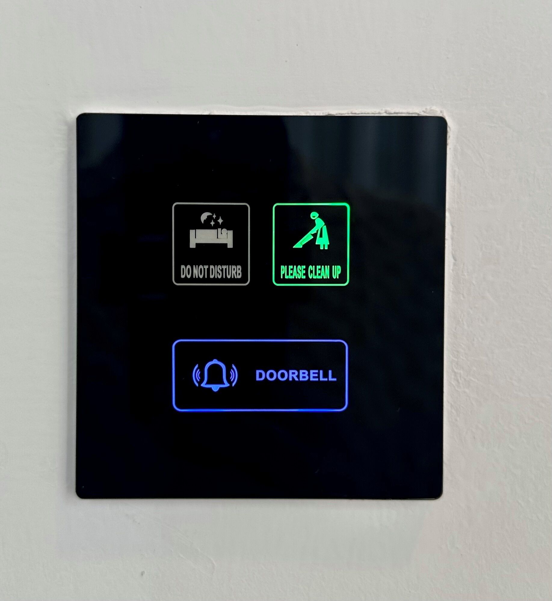 A control panel with three buttons: "DO NOT DISTURB," "PLEASE CLEAN UP," and "DOORBELL."
