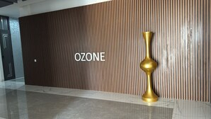 A modern interior with a wooden wall and the word "OZONE" prominently displayed. - Luxury apartment with lake view in Dakar (Dakar)