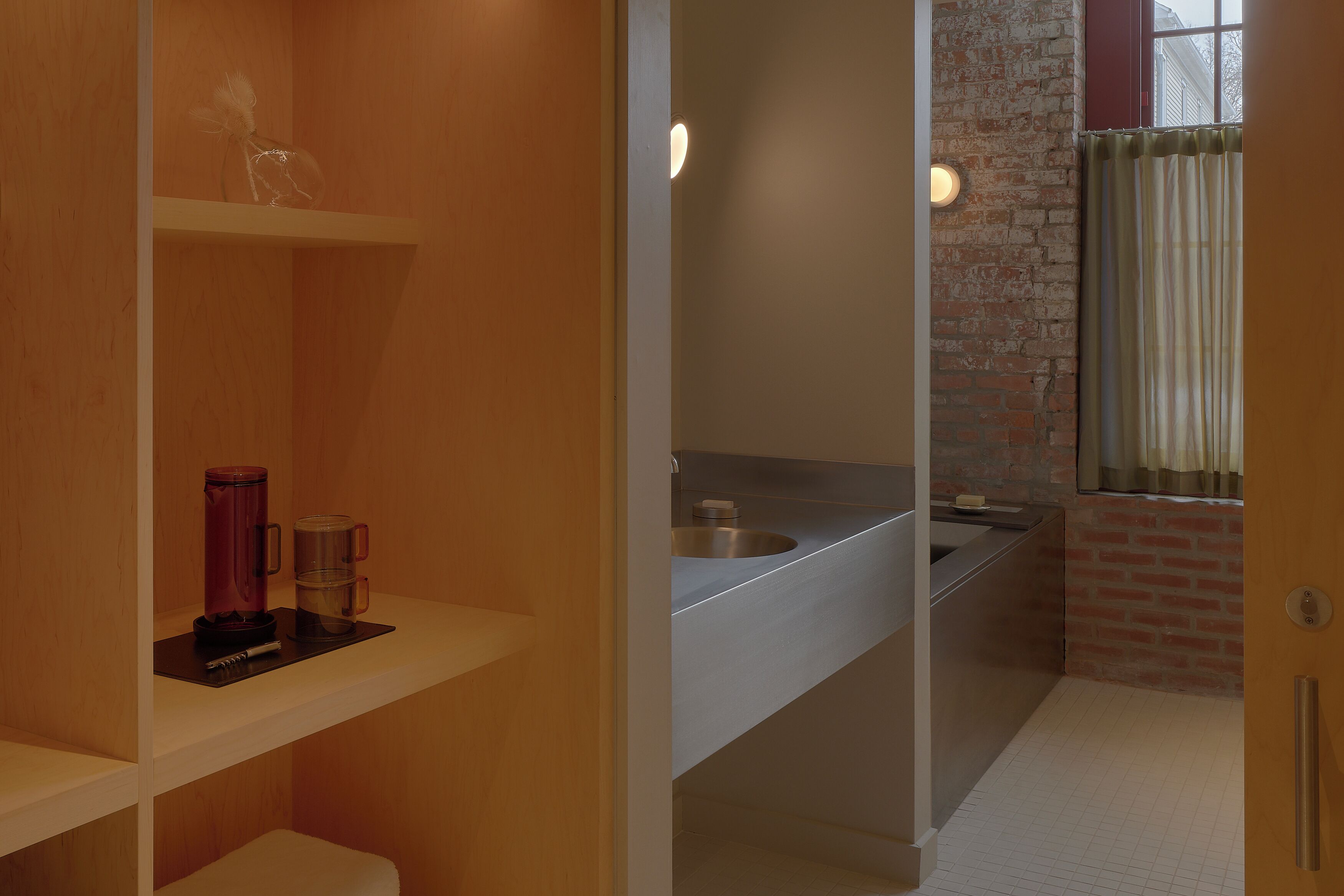 A modern bathroom with a shower, a sink, and a toilet.