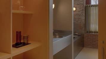 A modern bathroom with a shower, a sink, and a toilet.