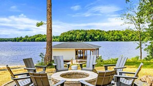 A lakeside deck with Adirondack chairs, a fire pit, and a small gazebo. - Lakefront Lake Anna, Beach, Dock, Deck Vie (Bumpass)