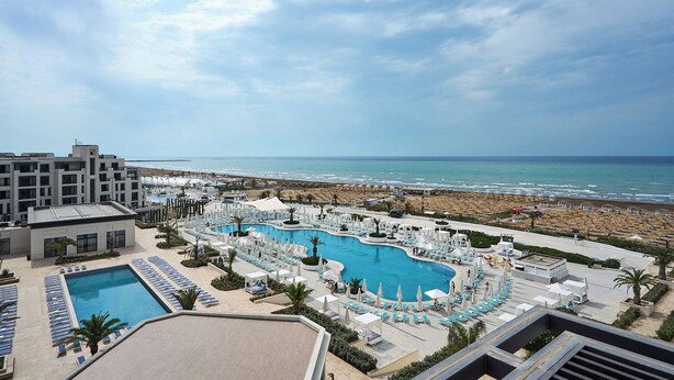 A resort with a large pool, beach access, and a view of the ocean. - Sea Breeze Stylish Studio with Private Terrace (Nardaran)