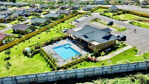 A residential area with houses, a swimming pool, and a gazebo.