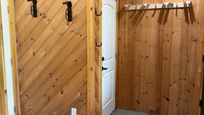 A wooden-paneled room with a white door, a coat rack, and a small wooden stool. - Mountain View 3-bedroom apartment in Carrabassett Valley 10 minutes to Sugarloaf (Carrabassett Valley)