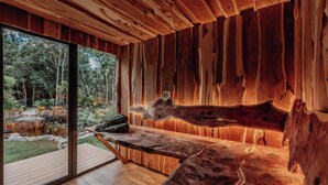 A wooden interior with a bench and a large window overlooking a natural landscape. - SOTA Human Space Retreat Centre & Wellness Adults Only (Puerto Morelos)