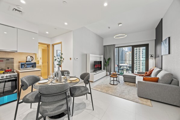 A modern apartment with a kitchen, dining area, and living room.