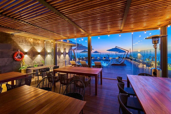 Stretch out by the rooftop pool with sunset horizons.