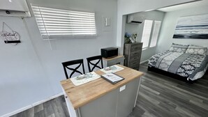 A compact room with a kitchenette, a bed, and a small dining area. - Walk To Beach, North End Restaurants, Night Life Steps Away! (Fort Myers Beach)
