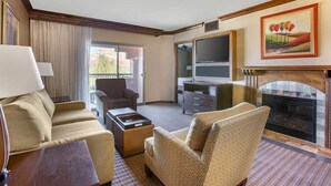 A hotel room with a sofa, armchair, TV, fireplace, and a painting on the wall. - NEW PRICE-Sedona Summit Resort-9/2/25-9/7/25, 2 Bedrooms, Sleeps 8-Best Location (Sedona)