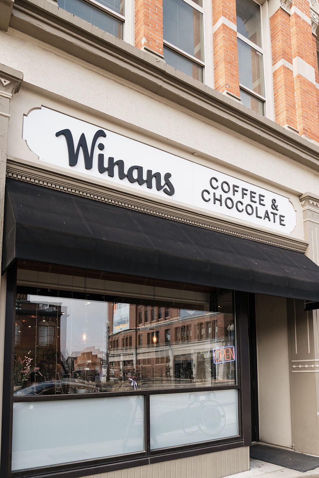 A storefront with a sign reading "Winans Coffee & Chocolate."