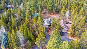 An aerial view of a residential area with multiple houses surrounded by dense forest. -  Super clean, quiet and comfy 3/2. (Sunriver)