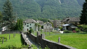 A village with stone walls, traditional buildings, and a mountainous backdrop. - Casa Calanca by Interhome (Grono)